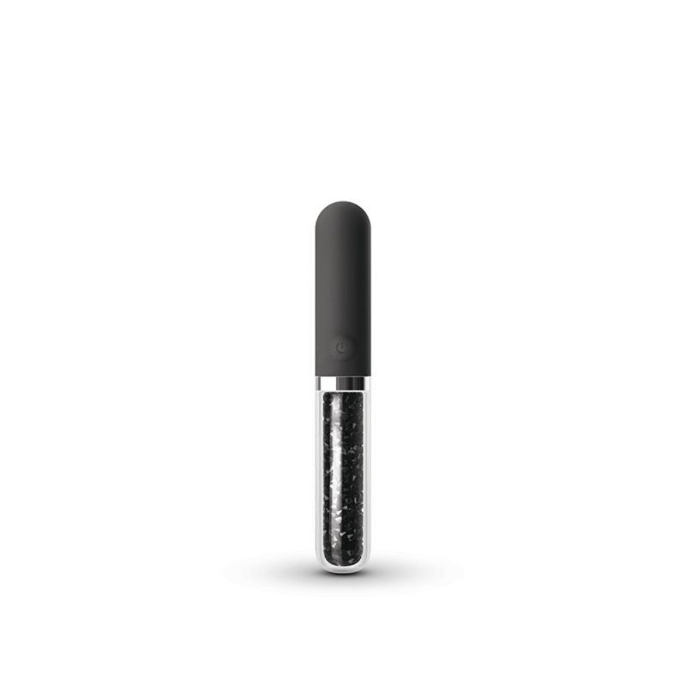 A dark grey silicone massager with a clear glass tube filled with dark particles.
