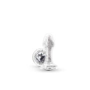 A clear glass anal plug with white crystals and a jeweled base.