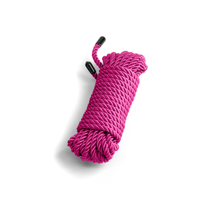 Pink soft cotton bondage rope with black capped ends.
