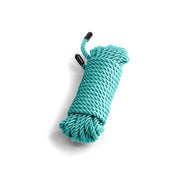 A coiled green cotton bondage rope with black capped ends.