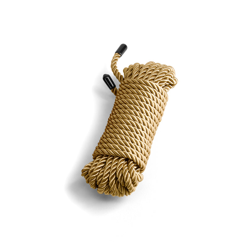 Gold soft bondage rope with black capped ends.