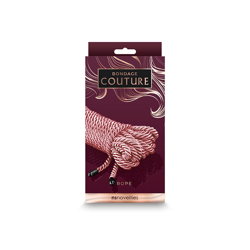 Rose gold bondage rope with black hardware on a burgundy box.