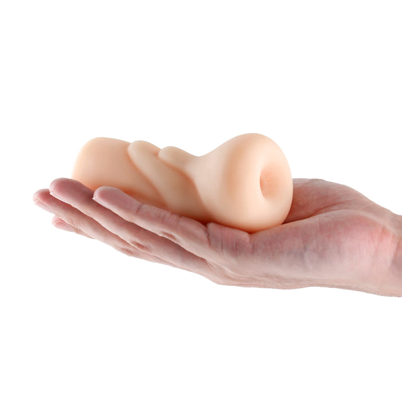 A realistic white TPE stroker held in a hand.