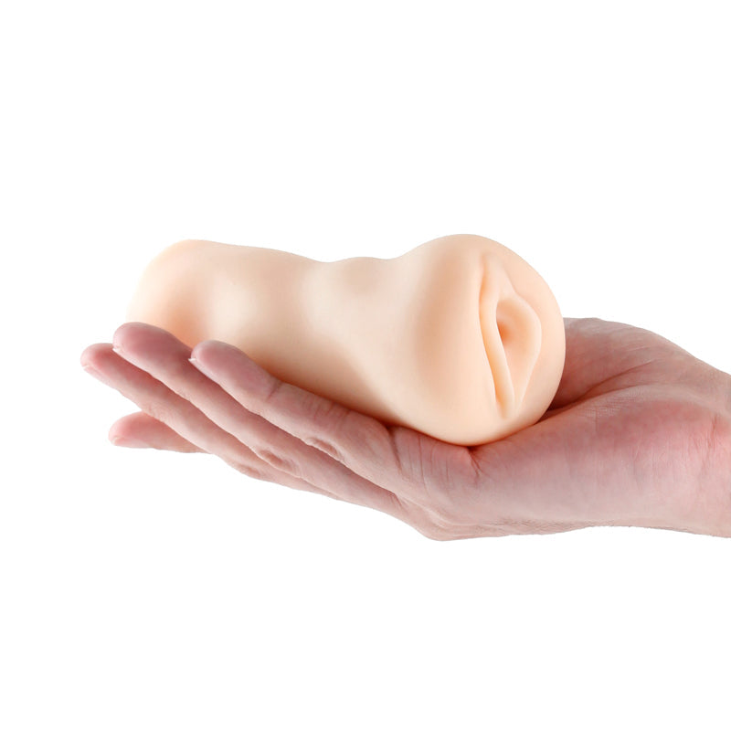 A hand holds a white textured male stroker.