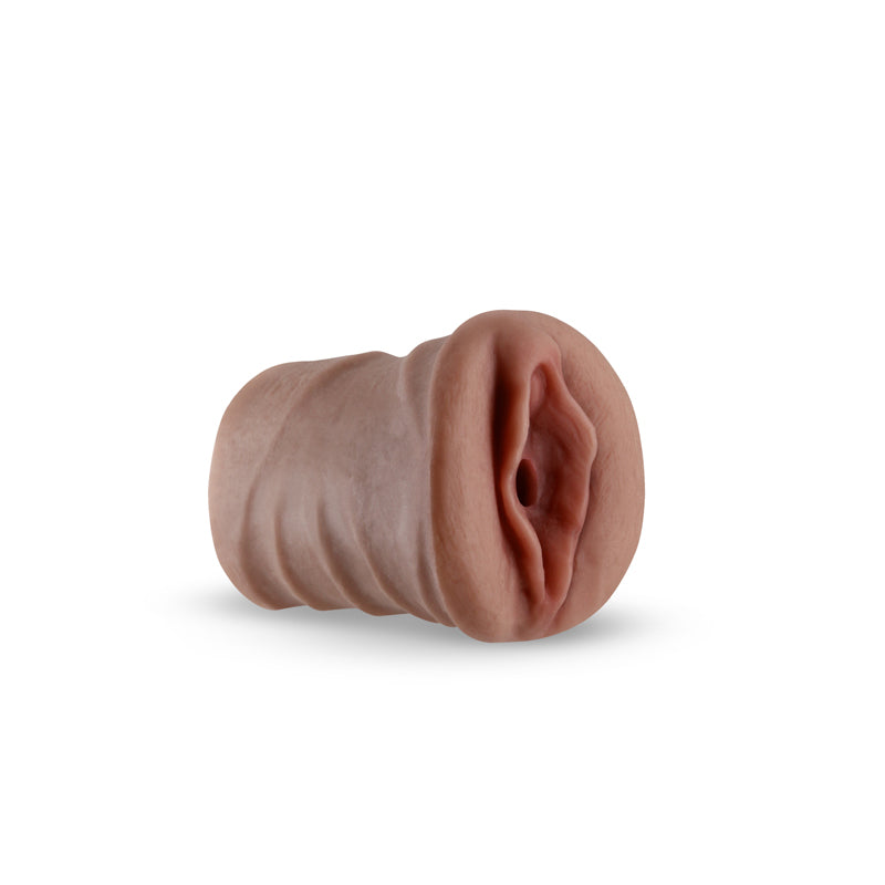 Realistic brown TPE male stroker with textured interior and lifelike vaginal opening.