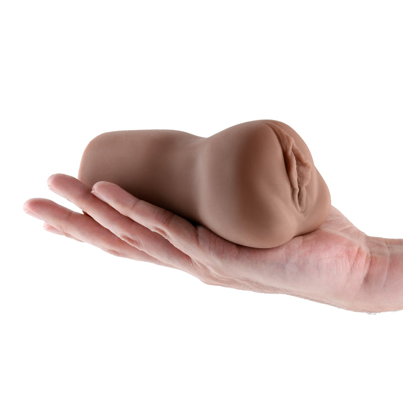 A realistic TPE male masturbator held in a hand.