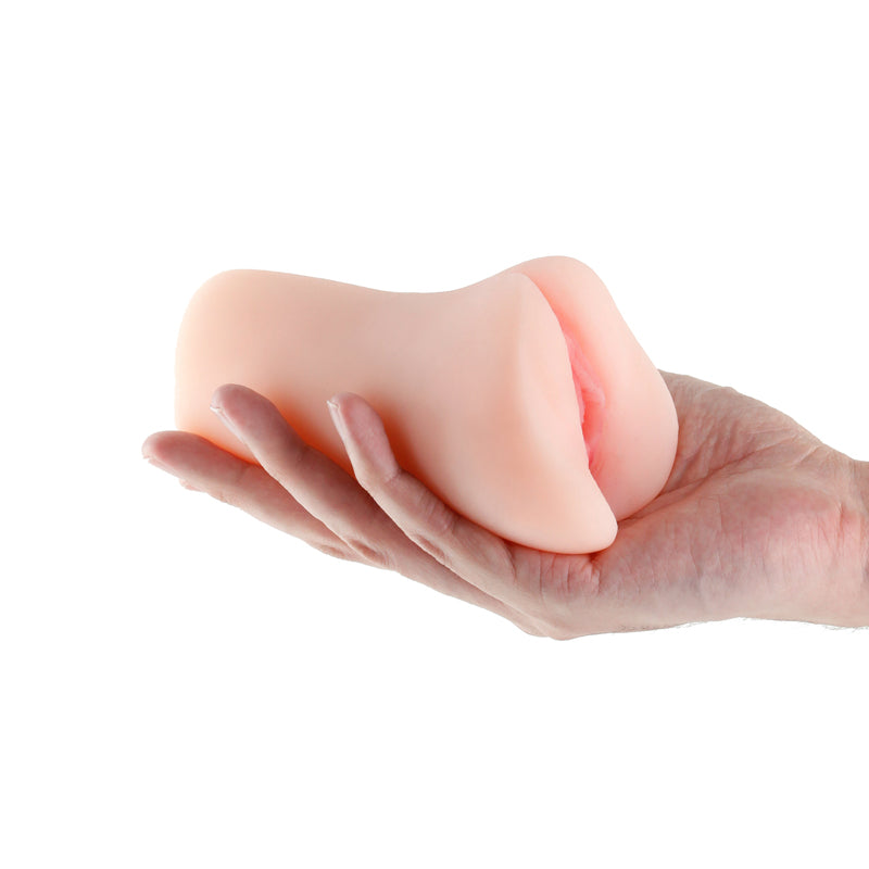 A hand holds a textured, flesh-colored male masturbator.