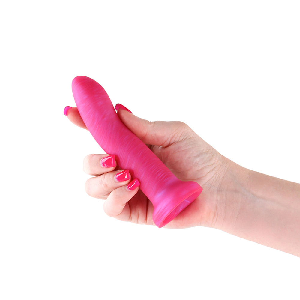 A hand holds a 5-inch metallic pink silicone suction cup dildo.