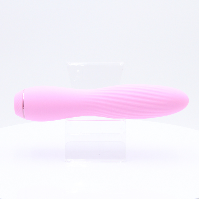 A light pink silicone vibrator with a ribbed texture.