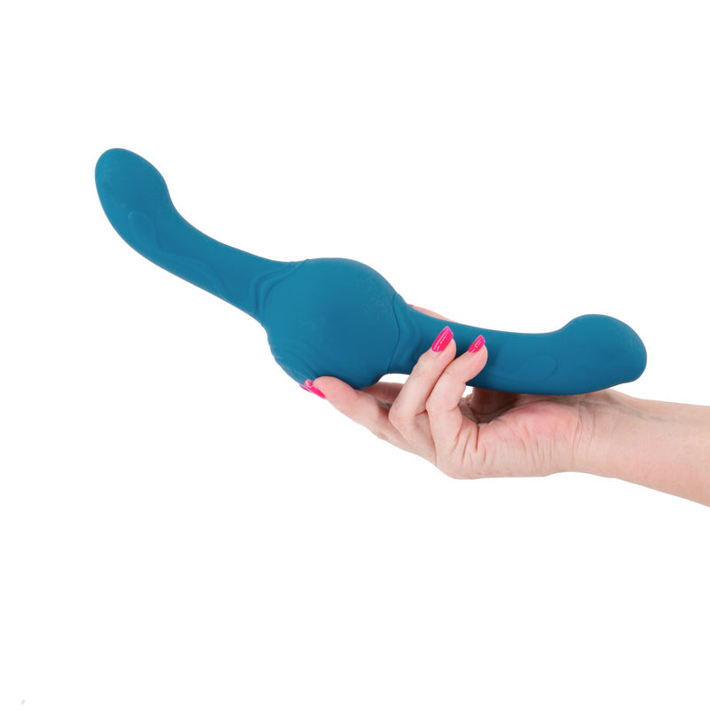 Teal rotating massager held in a hand.
