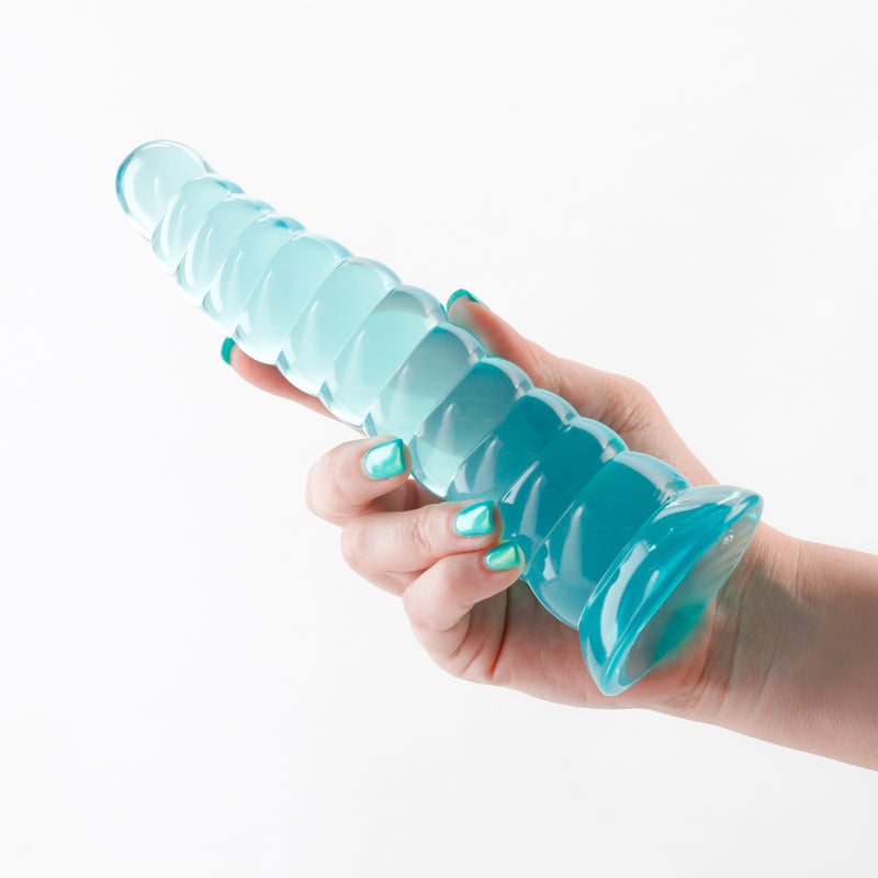 A teal flexible stimulating toy with a ribbed texture held in a hand.