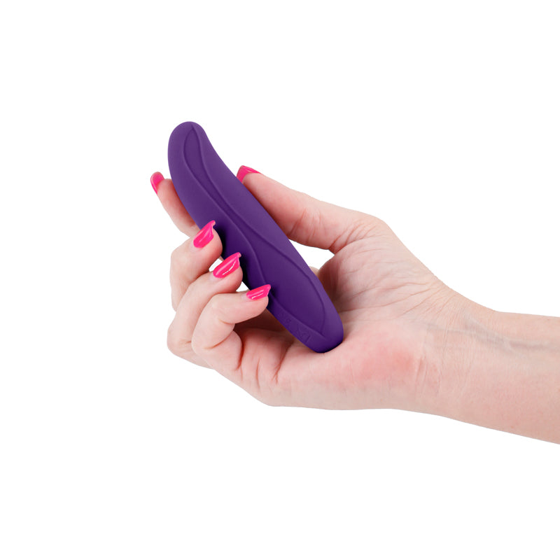 A hand holds a purple, flexible silicone vibrator.