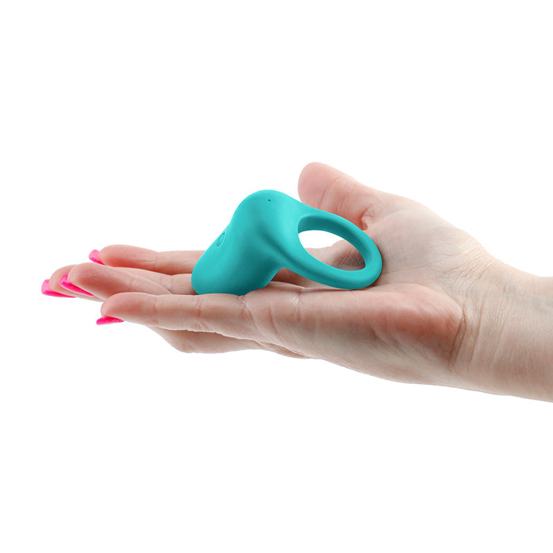 Teal rechargeable vibrating ring held in a hand.