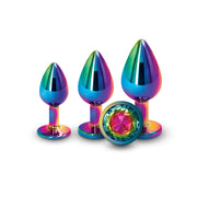 Three rainbow-colored anal plugs of graduated sizes with a jeweled base.