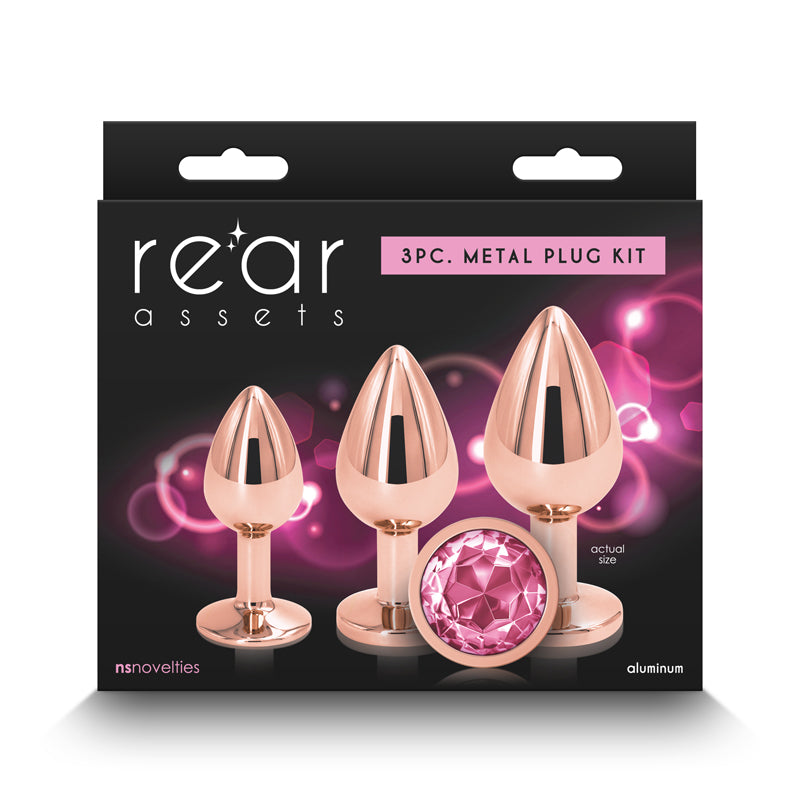 Rose gold metal anal plug kit with three graduated sizes and a pink gem accent.