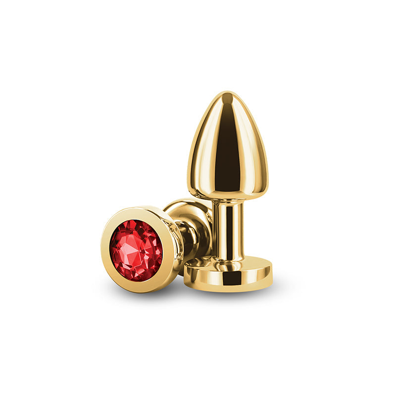 Gold-toned anal plug with a red gem and a flared base.