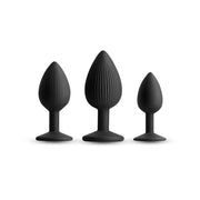 Three black ribbed silicone anal plugs of varying sizes.