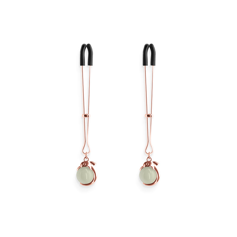 Adjustable rose gold nipple clamps with silicone tips and pale green charms.