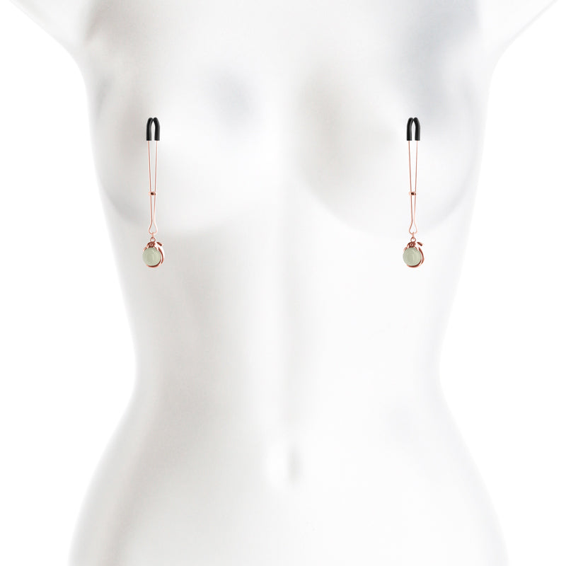 Adjustable nipple clamps with silicone tips and a dangling charm.