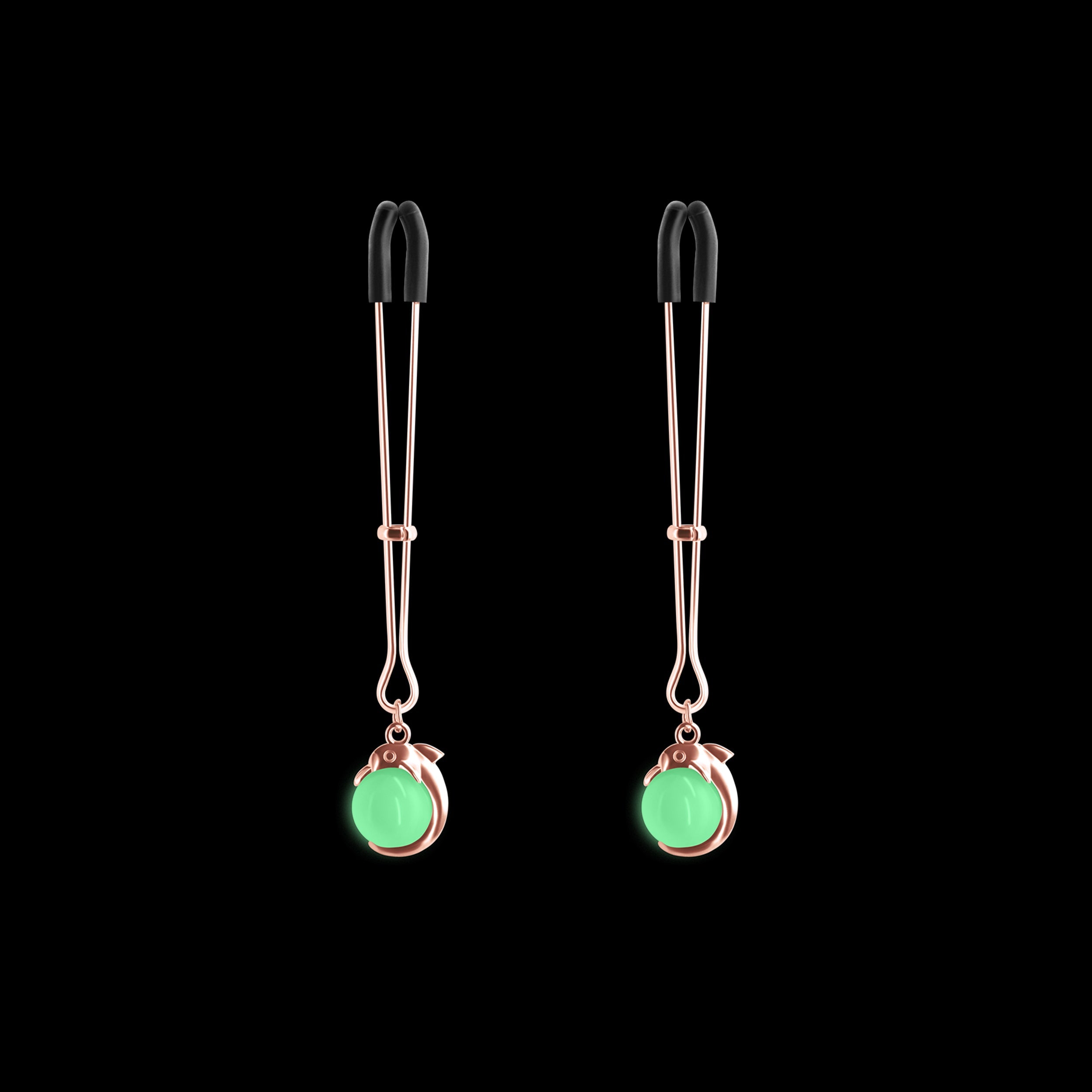 Adjustable rose gold nipple clamps with silicone tips and glowing green charms.