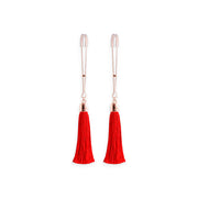 Adjustable nipple clamps with red tassels and silicone tips.