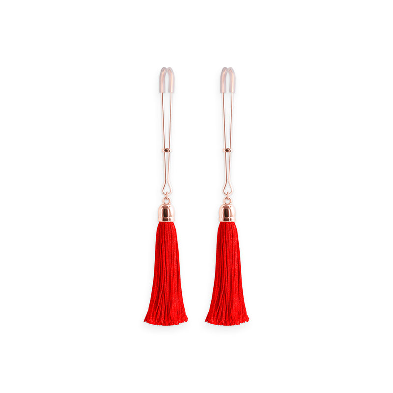 Adjustable nipple clamps with red tassels and silicone tips.
