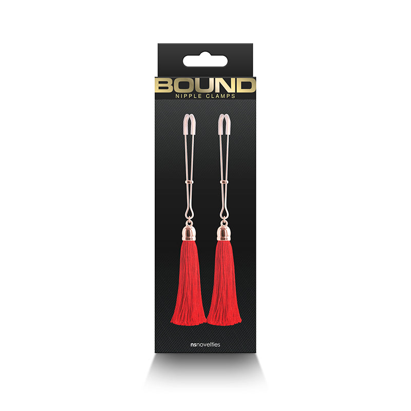 Nipple clamps with red tassels and silicone tips in packaging.