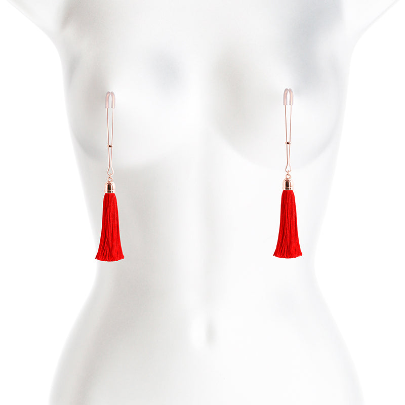 Adjustable nipple clamps with red tassels and silicone tips.
