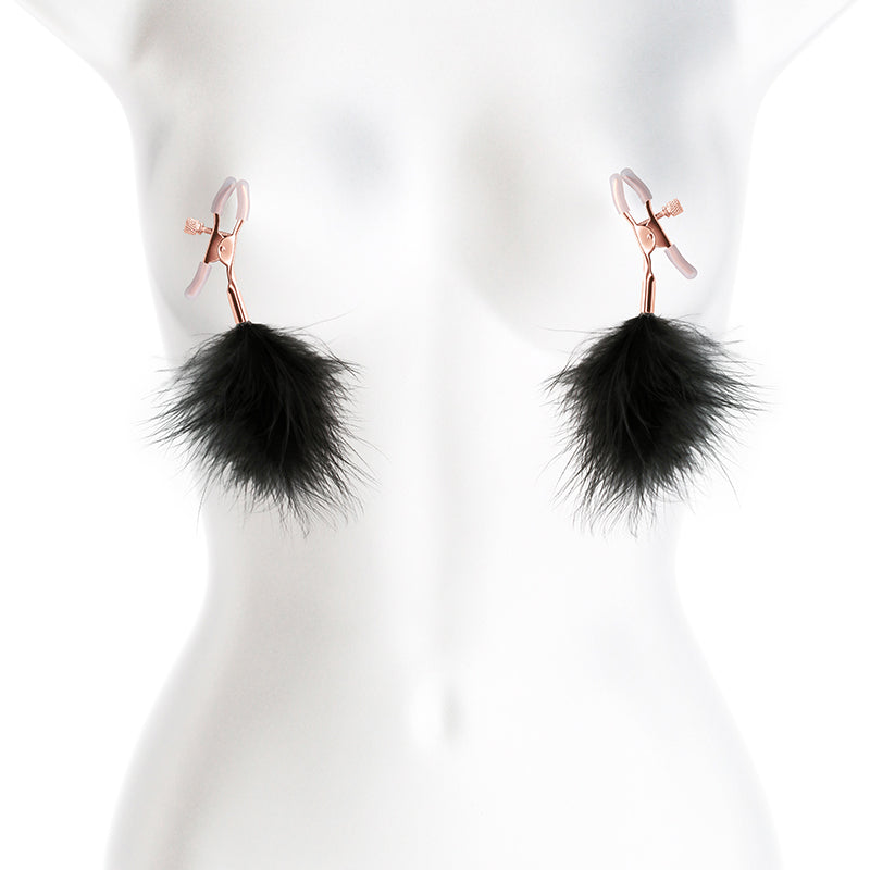 Adjustable nipple clamps with black feather poms on a mannequin.
