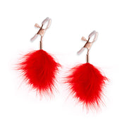 Adjustable nipple clamps with red feather poms.
