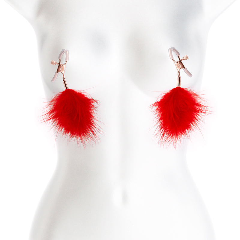 Adjustable nipple clamps with red feather poms on a mannequin.