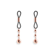 Adjustable rose gold nipple clamps with silicone tips.
