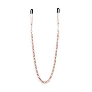 Rose gold adjustable nipple clamps with silicone tips and a connecting chain.