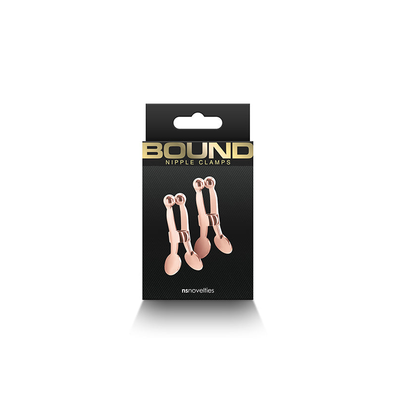 Rose gold ball-tipped nipple clamps on a black box.