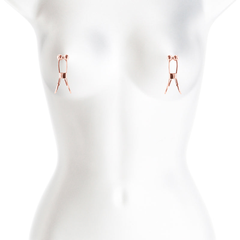Rose gold ball-tipped nipple clamps on a white mannequin.