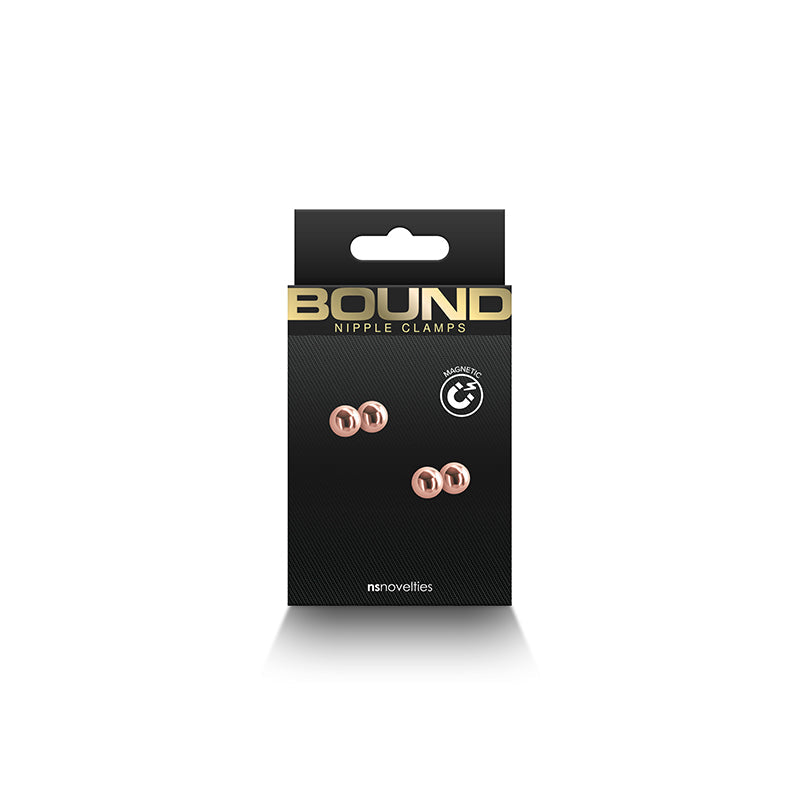 Rose gold magnetic nipple clamps with silicone tips on a black card.