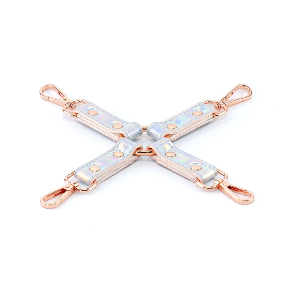 Four rainbow holographic restraints with rose gold hardware arranged in a cross shape.