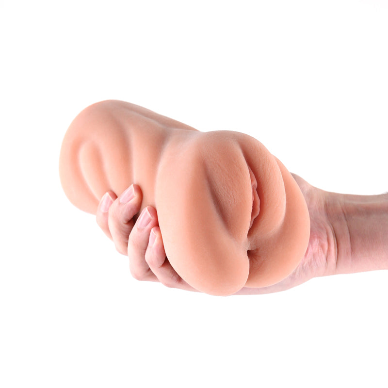 A hand holds a realistic pink TPE stroker with textured shaft.