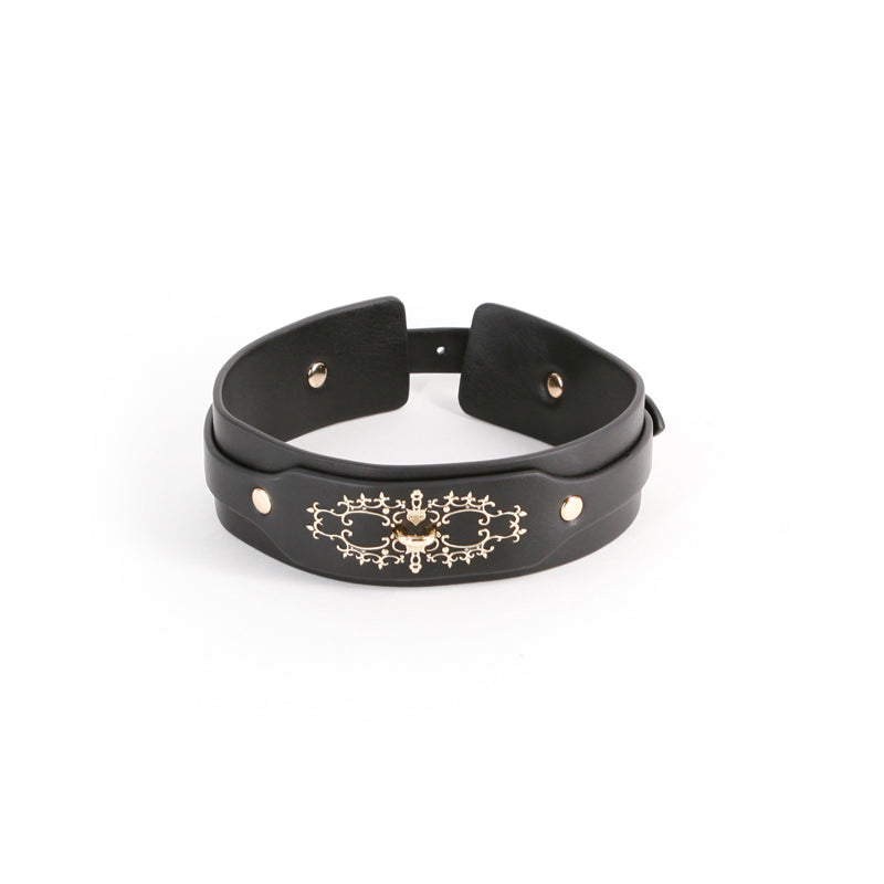 Black faux leather collar with gold ornate embellishments and a D-ring.