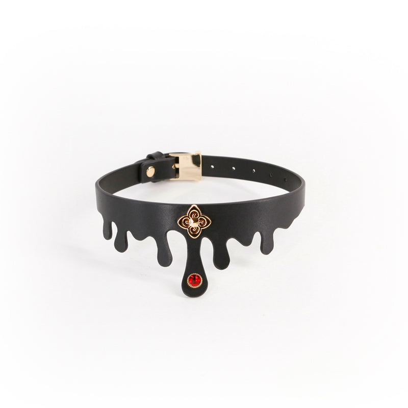 Black faux leather collar with dripping detail, gold charm, and ruby jewel.