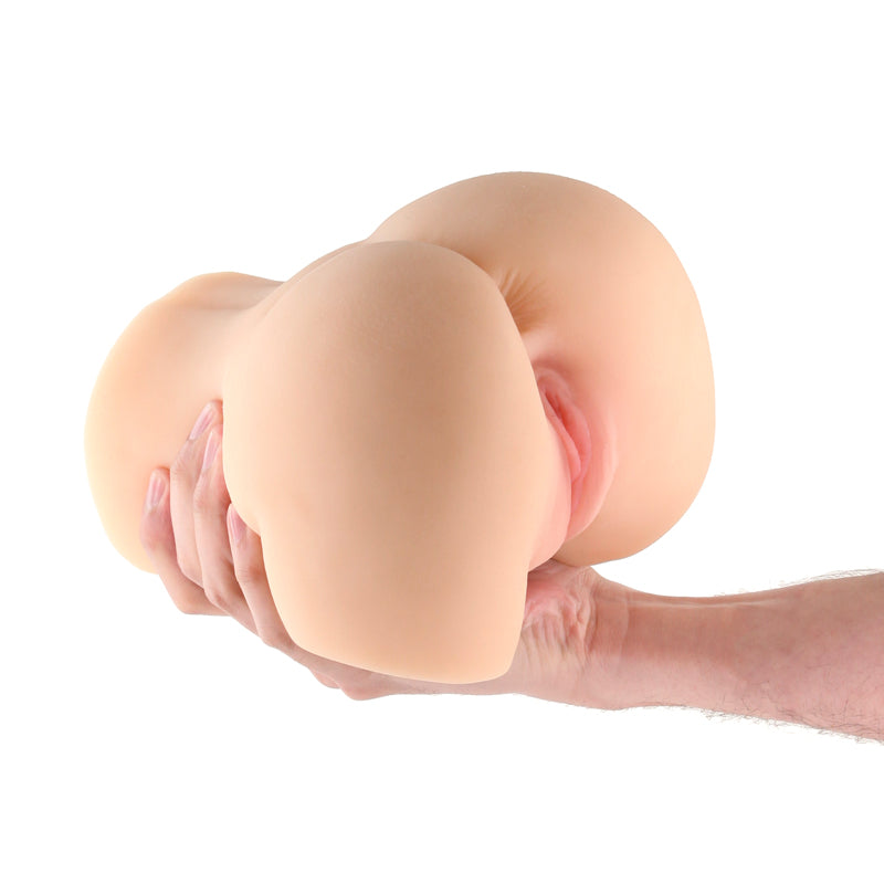 Hazel Tan Textured TPE Stroker Sleeve held by a hand, showing realistic curves.