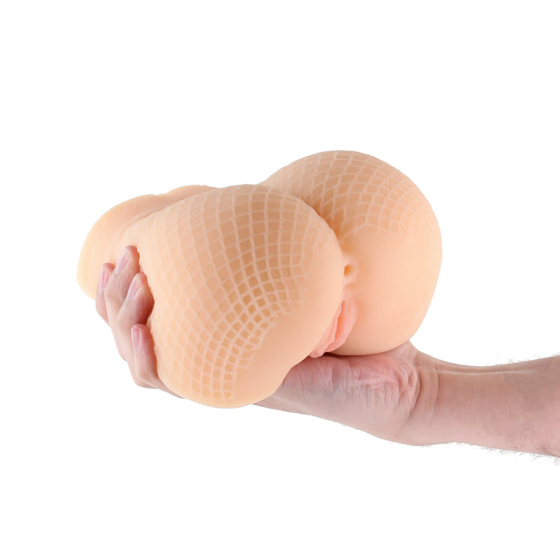 Tan textured fishnet stroker held in a hand.