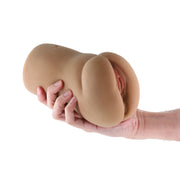 A hand holds a brown TPE male stroker with textured interior and realistic design.