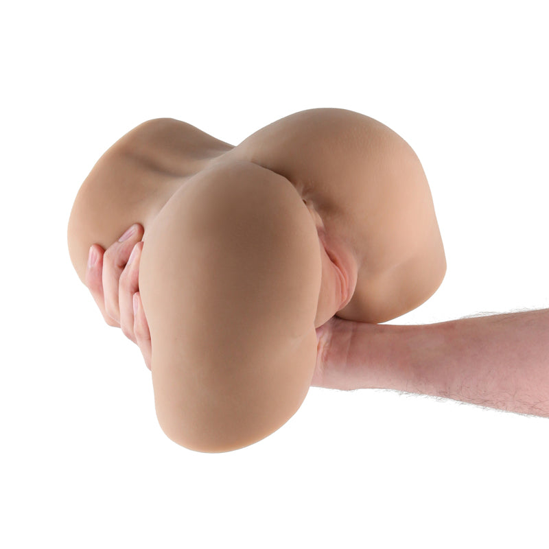 Realistic brown TPE male masturbator with textured interior, held in hand.