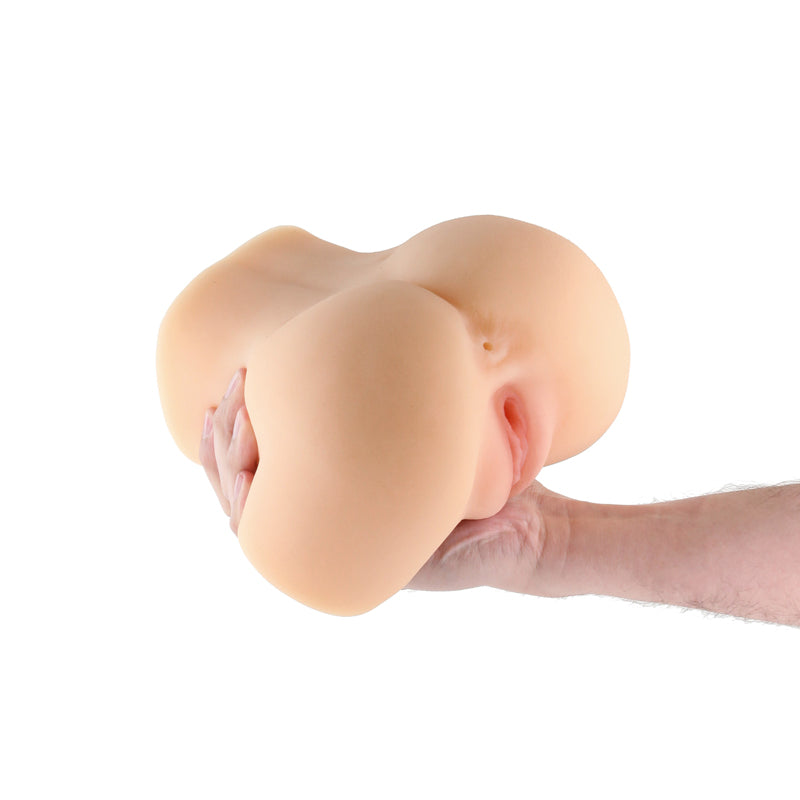 Tan TPE male stroker with textured interior held in a hand.