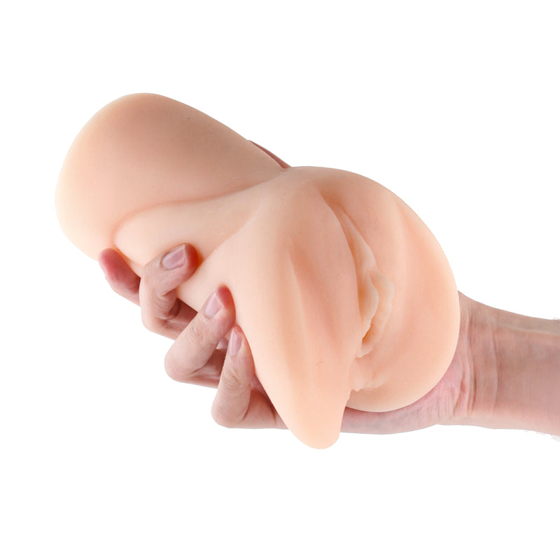 A hand holds a white textured TPE stroker with a realistic opening.