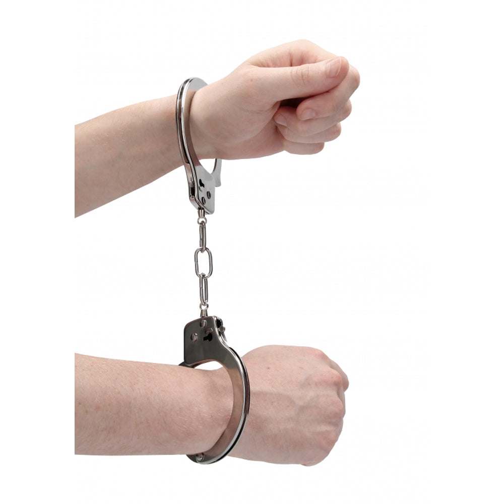 Metal handcuffs with a quick-release mechanism on a white background.