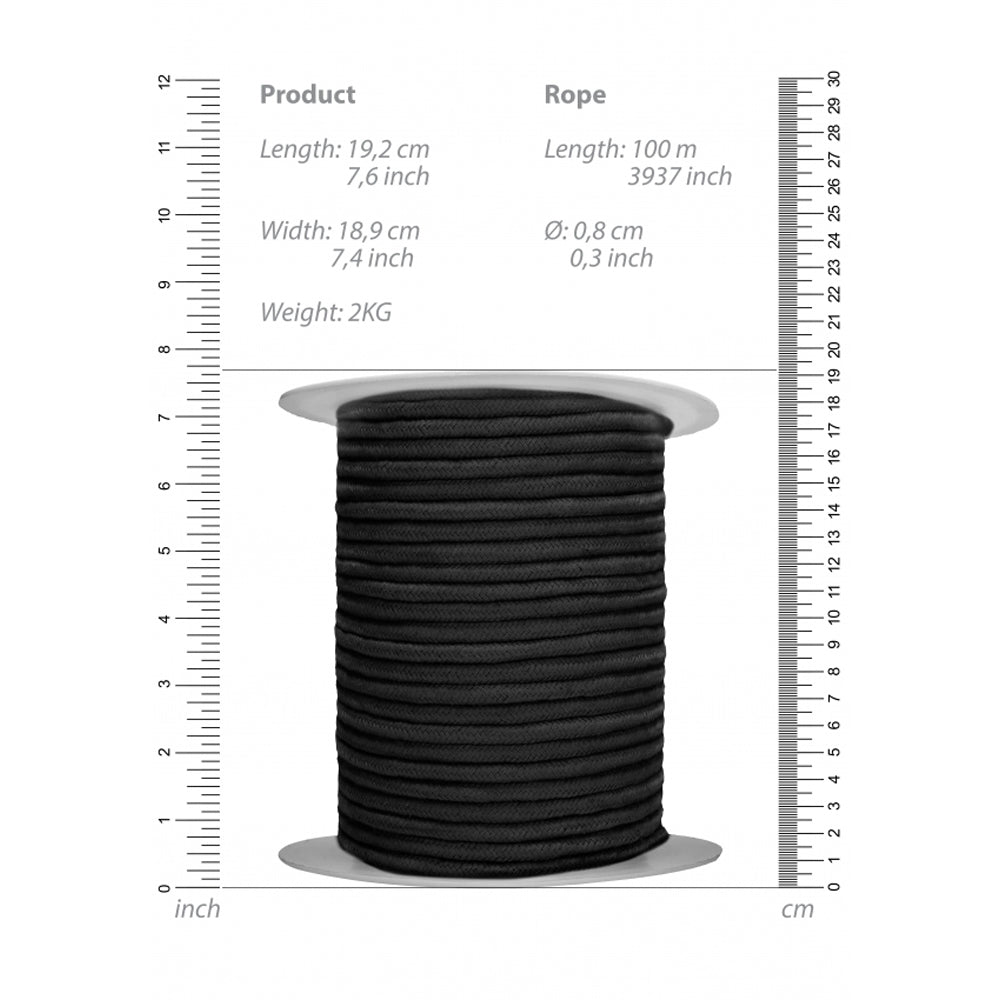 A spool of black cotton bondage rope with measurements in inches and centimeters.