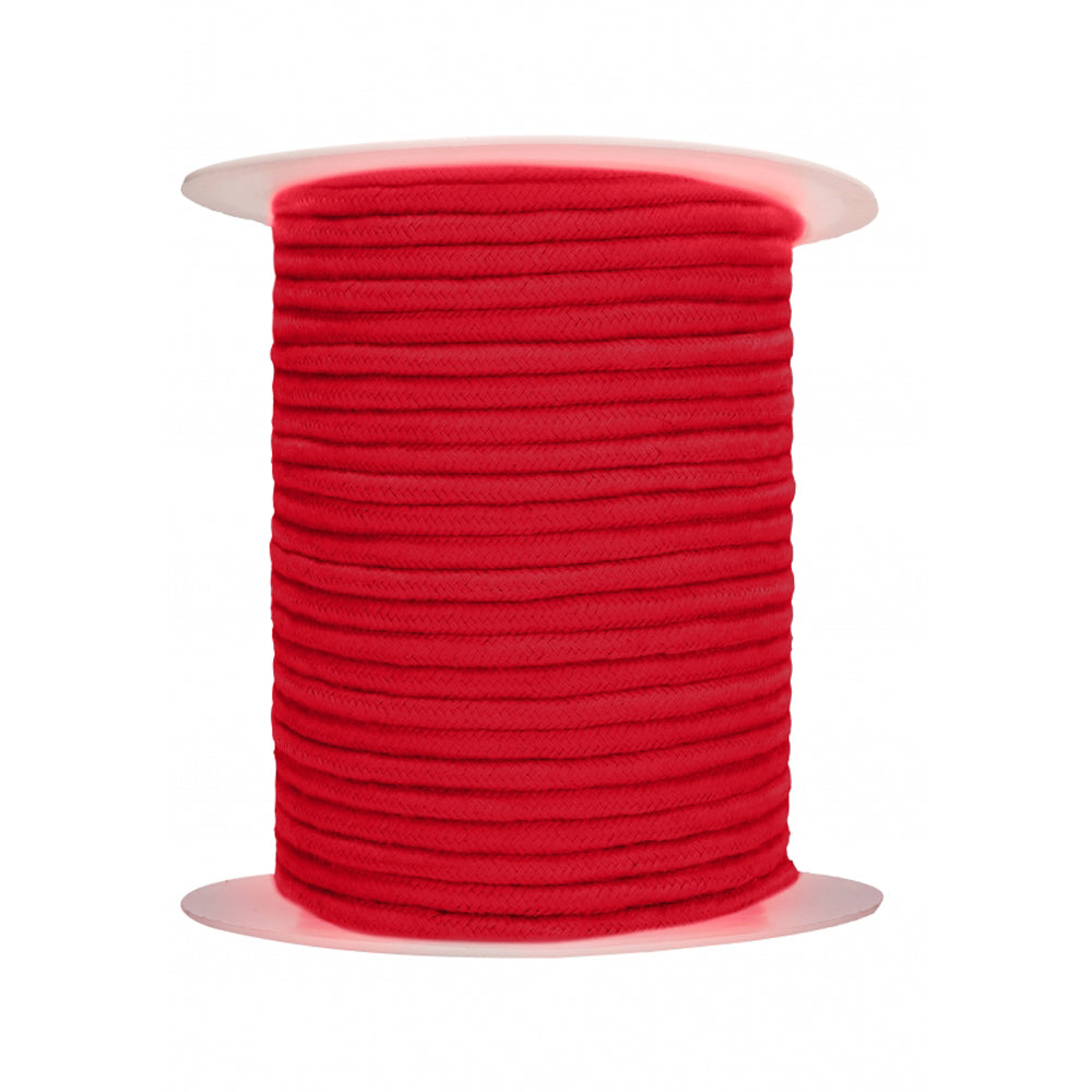 Red cotton rope wound on a spool.
