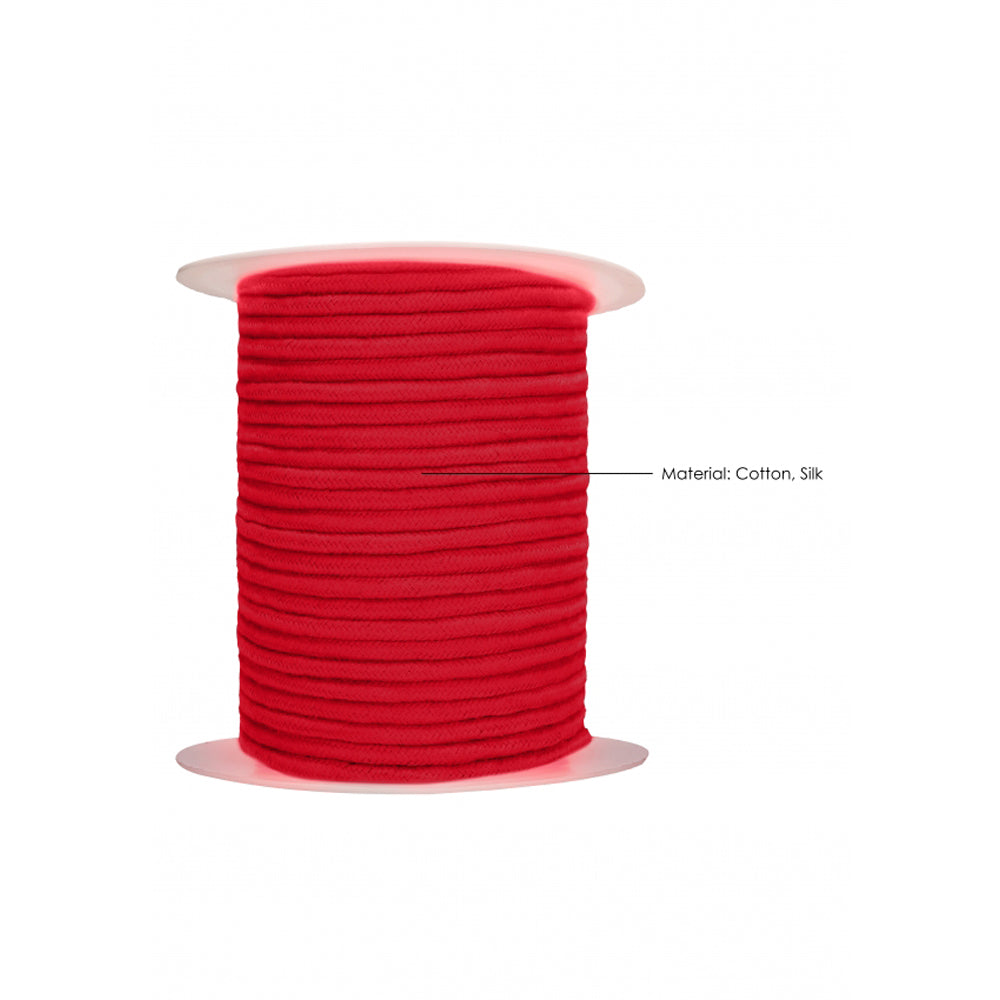 Red cotton rope on a spool, labeled as cotton and silk material.